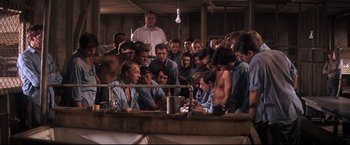 Movie still from “Cool Hand Luke” (1967), directed by Stuart Rosenberg – A group of people gathered around a table; Wide shot, High angle