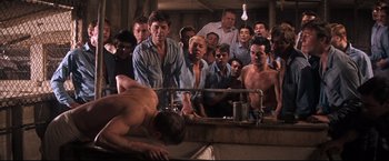 Movie still from “Cool Hand Luke” (1967), directed by Stuart Rosenberg – A group of men standing in front of a mirror; Wide shot, High angle