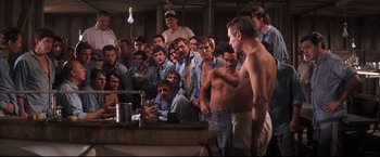 Movie still from “Cool Hand Luke” (1967), directed by Stuart Rosenberg – A group of men standing in front of a mirror; Wide shot, High angle