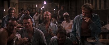 Movie still from “Cool Hand Luke” (1967), directed by Stuart Rosenberg – A group of people sitting in a room; Medium shot, High angle