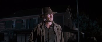 Movie still from “Cool Hand Luke” (1967), directed by Stuart Rosenberg – A man wearing a hat and a brown jacket; Medium shot, Low angle