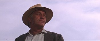 Movie still from “Cool Hand Luke” (1967), directed by Stuart Rosenberg – An older man wearing a suit and a hat; Close Up shot, Low angle