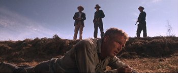 Movie still from “Cool Hand Luke” (1967), directed by Stuart Rosenberg – Two men standing on top of a hill; Medium shot, Low angle