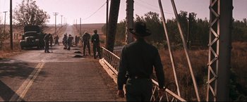 Movie still from “Cool Hand Luke” (1967), directed by Stuart Rosenberg – A group of people walking across a bridge; Wide shot, Low angle