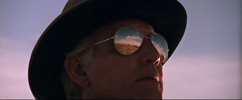 Movie still from “Cool Hand Luke” (1967), directed by Stuart Rosenberg – A man wearing a hat and sunglasses looking into the distance; Close Up shot, Low angle