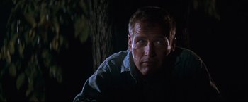 Movie still from “Cool Hand Luke” (1967), directed by Stuart Rosenberg – A person wearing a shirt near a tree; Close Up shot, Low angle