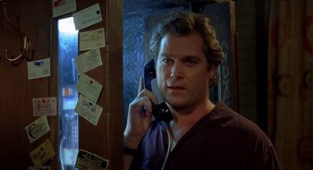 Movie still from “Cop Land” (1997), directed by James Mangold – A man holding a phone up to his ear; Close Up shot, Low angle