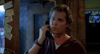 Movie still from “Cop Land” (1997), directed by James Mangold – A man holding a phone up to his ear; Close Up shot, Low angle