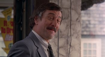 Movie still from “Cop Land” (1997), directed by James Mangold – A person wearing a suit and tie; Close Up shot, Low angle