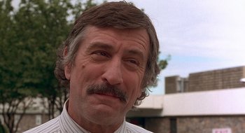 Movie still from “Cop Land” (1997), directed by James Mangold – A person with a mustache; Close Up shot, Low angle