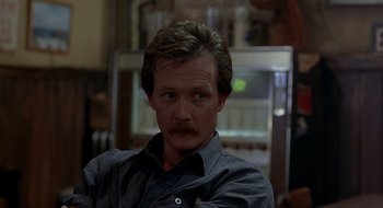 Movie still from “Cop Land” (1997), directed by James Mangold – A person wearing a shirt; Close Up shot, Over the shoulder angle