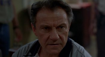 Movie still from “Cop Land” (1997), directed by James Mangold – An older man is looking into the camera; Close Up shot, Low angle