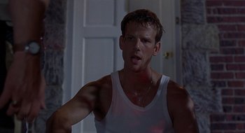 Movie still from “Cop Land” (1997), directed by James Mangold – A man in a white tank top looking at the camera; Close Up shot, Low angle