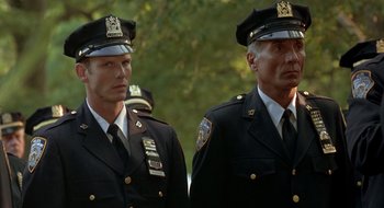 Movie still from “Cop Land” (1997), directed by James Mangold – Two men in police uniforms standing next to each other; Medium shot, Low angle