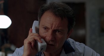 Movie still from “Cop Land” (1997), directed by James Mangold – A person talking on a cell phone; Close Up shot, Low angle