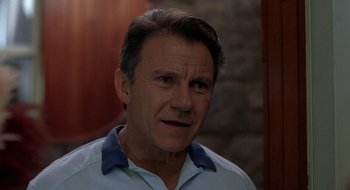 Movie still from “Cop Land” (1997), directed by James Mangold – A person wearing a blue shirt; Close Up shot, Low angle