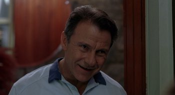 Movie still from “Cop Land” (1997), directed by James Mangold – A person wearing a blue shirt; Close Up shot, Low angle