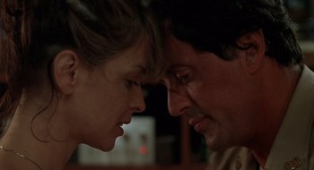 Movie still from “Cop Land” (1997), directed by James Mangold – A man and a woman looking at each other's faces; Close Up shot, Low angle