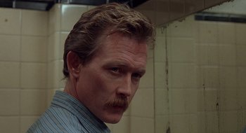 Movie still from “Cop Land” (1997), directed by James Mangold – A person with a mustache; Close Up shot, Over the shoulder angle
