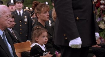 Movie still from “Cop Land” (1997), directed by James Mangold – A woman and a little girl sitting next to each other; Close Up shot, Over the shoulder angle