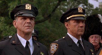 Movie still from “Cop Land” (1997), directed by James Mangold – Two police officers standing next to each other in uniform; Close Up shot, Low angle
