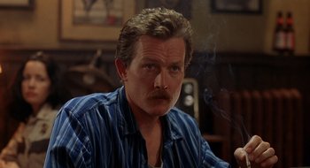 Movie still from “Cop Land” (1997), directed by James Mangold – A person sitting in a room; Close Up shot, Over the shoulder angle