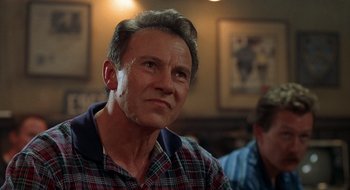 Movie still from “Cop Land” (1997), directed by James Mangold – A person wearing a plaid shirt; Close Up shot, Low angle