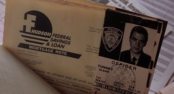 Movie still from “Cop Land” (1997), directed by James Mangold – An old police officer's id is on top of an envelope; Extreme Close Up shot, Overhead angle