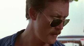 Movie still from “Cop Land” (1997), directed by James Mangold – A person wearing sunglasses; Close Up shot, Low angle