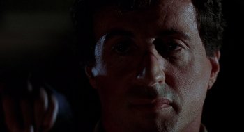 Movie still from “Cop Land” (1997), directed by James Mangold – A man's face in the dark; Close Up shot, Over the shoulder angle
