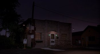 Movie still from “Cop Land” (1997), directed by James Mangold – A building that is lit up at night time; Extreme Wide shot, Low angle