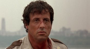 Movie still from “Cop Land” (1997), directed by James Mangold – A man with a bandage on his face; Close Up shot, Low angle