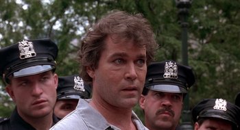 Movie still from “Cop Land” (1997), directed by James Mangold – A person wearing a police uniform; Close Up shot, Low angle