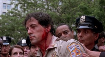 Movie still from “Cop Land” (1997), directed by James Mangold – A police officer with blood all over his face; Close Up shot, Over the shoulder angle