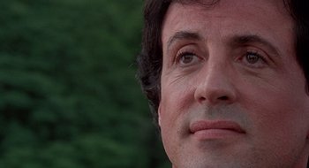 Movie still from “Cop Land” (1997), directed by James Mangold – A man's face with trees in the background; Close Up shot, Low angle