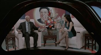 Movie still from “Cosmopolis” (2012), directed by David Cronenberg – A man and a woman sitting in a living room; Wide shot, High angle