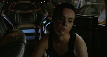 Movie still from “Cosmopolis” (2012), directed by David Cronenberg – A woman sitting in a car looking at the camera; Close Up shot, Over the shoulder angle