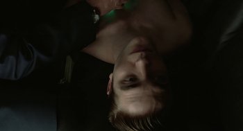 Movie still from “Cosmopolis” (2012), directed by David Cronenberg – A young man is laying in a dark room; Close Up shot, Over the shoulder angle