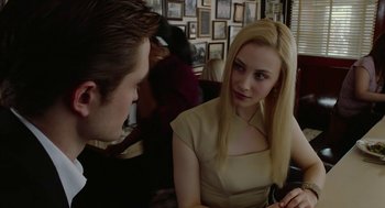 Movie still from “Cosmopolis” (2012), directed by David Cronenberg – A man and a woman sitting at a table talking to each other; Close Up shot, Over the shoulder angle