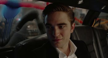 Movie still from “Cosmopolis” (2012), directed by David Cronenberg – A person sitting in a car; Close Up shot, Over the shoulder angle