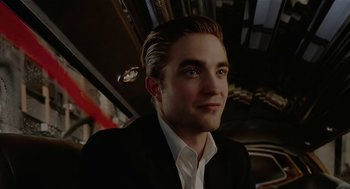 Movie still from “Cosmopolis” (2012), directed by David Cronenberg – A person wearing a suit and tie; Close Up shot, Low angle
