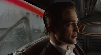 Movie still from “Cosmopolis” (2012), directed by David Cronenberg – A person sitting in a car; Close Up shot, Over the shoulder angle