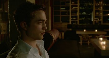 Movie still from “Cosmopolis” (2012), directed by David Cronenberg – A man in a white shirt is looking to his left; Close Up shot, Over the shoulder angle
