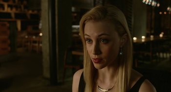 Movie still from “Cosmopolis” (2012), directed by David Cronenberg – A woman with blonde hair wearing a black top; Close Up shot, Over the shoulder angle