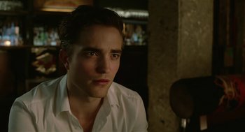 Movie still from “Cosmopolis” (2012), directed by David Cronenberg – A person wearing a white shirt; Close Up shot, Over the shoulder angle