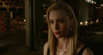 Movie still from “Cosmopolis” (2012), directed by David Cronenberg – A woman with long blonde hair wearing a black top; Close Up shot, Over the shoulder angle