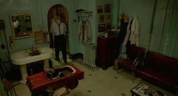 Movie still from “Cosmopolis” (2012), directed by David Cronenberg – Two men in a room with a sink and a mirror; Wide shot, High angle