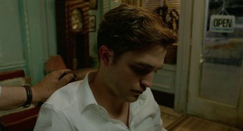 Movie still from “Cosmopolis” (2012), directed by David Cronenberg – A person with a white shirt; Close Up shot, Over the shoulder angle