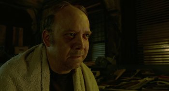 Movie still from “Cosmopolis” (2012), directed by David Cronenberg – A person with a towel around his neck; Close Up shot, Low angle