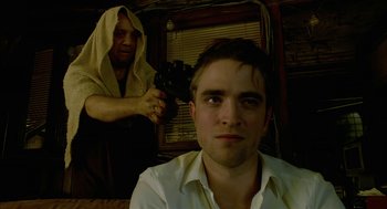 Movie still from “Cosmopolis” (2012), directed by David Cronenberg – A man is getting his hair combed by another man; Close Up shot, Over the shoulder angle